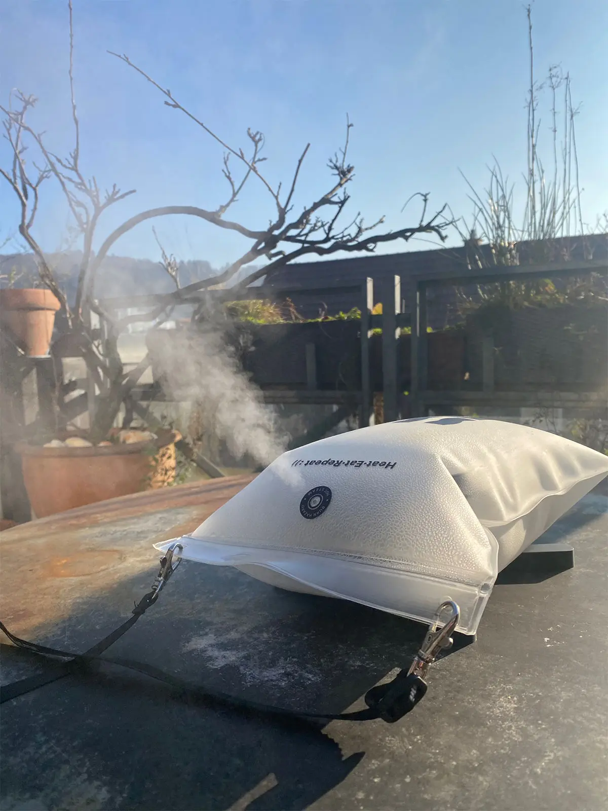 Steaming lunch box rests on silicone folding coaster